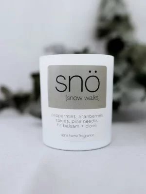 white candle jar with label saying sno